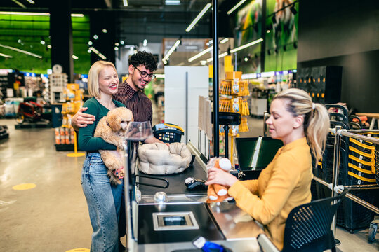 Pet store associate checking out customer with tablet POS on store floor